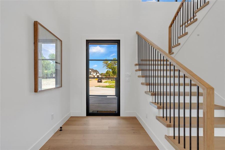 Foyer with wood finished floors and stairs Foyer with wood finished floors and stairs