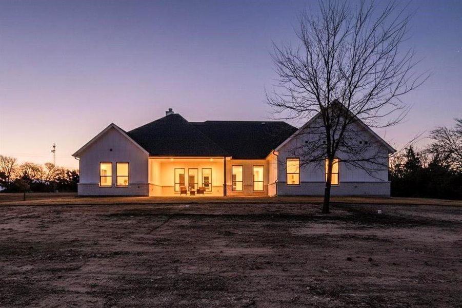 Back of house featuring a patio area and a chimney