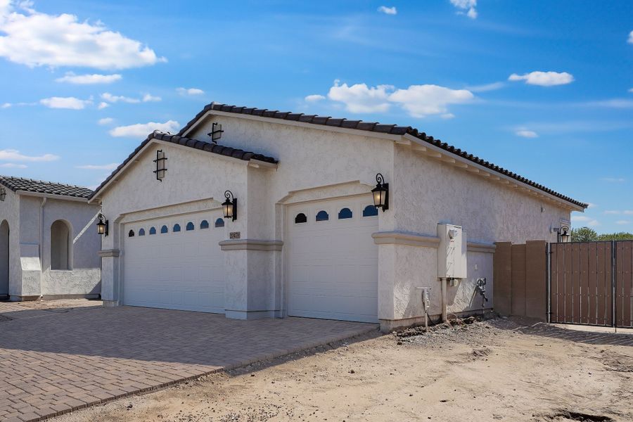 Front exterior of a new home in Ellsworth Ranch, Queen Creek, AZ, highlighting curb appeal (Image 2). Front exterior of a new home in Ellsworth Ranch, Queen Creek, AZ, highlighting curb appeal (Image 2).
