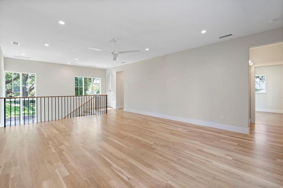 Spare room featuring light wood-type flooring and ceiling fan