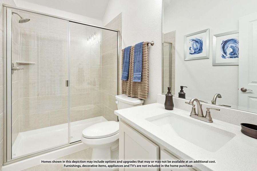 Bathroom with glass-enclosed shower, white vanity with single sink, and beige tile walls Bathroom with glass-enclosed shower, white vanity with single sink, and beige tile walls