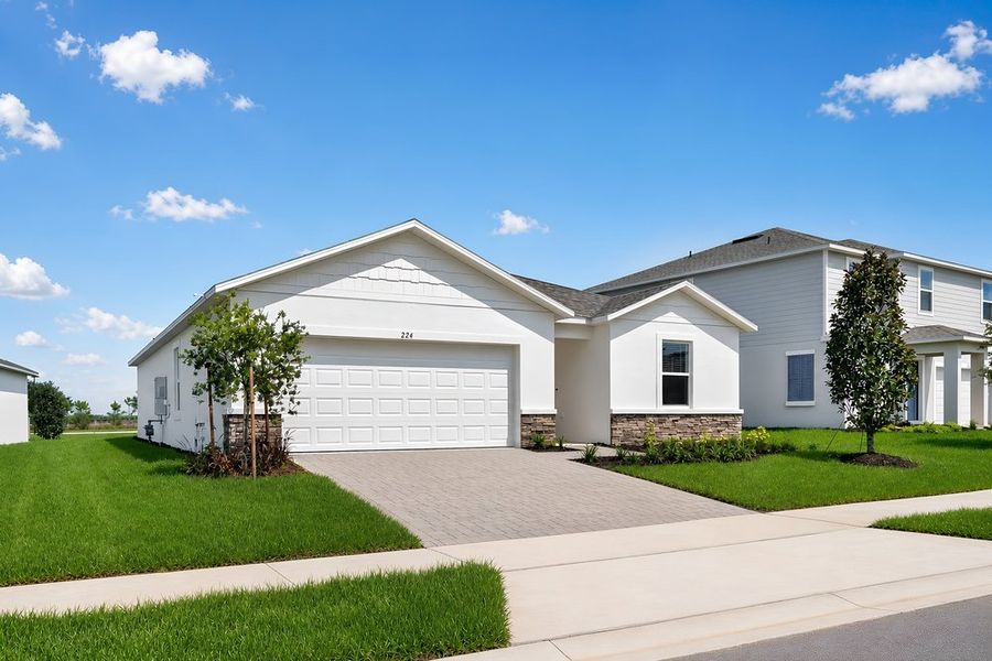 Front exterior of a new home in Waterstone, Groveland, FL, highlighting curb appeal (Image 2). Front exterior of a new home in Waterstone, Groveland, FL, highlighting curb appeal (Image 2).