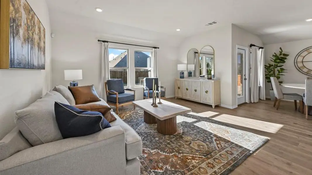 Living area with dark wood-style floors, recessed lighting, and lofted ceiling