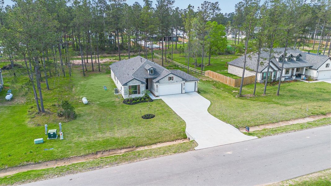 Front exterior of a new home in Deer Pines, Conroe, TX, highlighting curb appeal (Image 22).