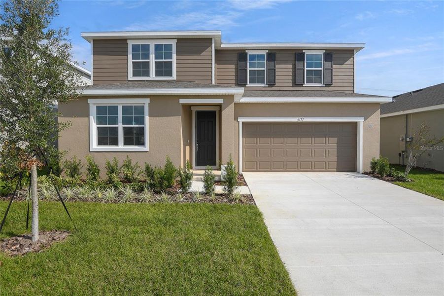 Front exterior of a new home in Seasons at Scenic Terrace, Lake Hamilton, FL, highlighting curb appeal (Image 1). Front exterior of a new home in Seasons at Scenic Terrace, Lake Hamilton, FL, highlighting curb appeal (Image 1).