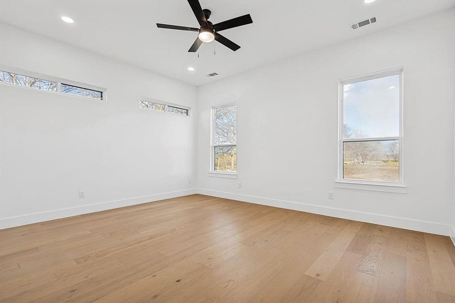 Spare room with ceiling fan and light hardwood / wood-style flooring