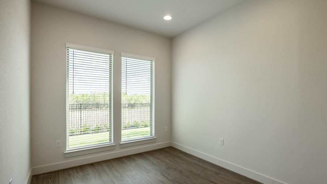 Unfurnished room featuring dark wood-style flooring and recessed lighting Unfurnished room featuring dark wood-style flooring and recessed lighting