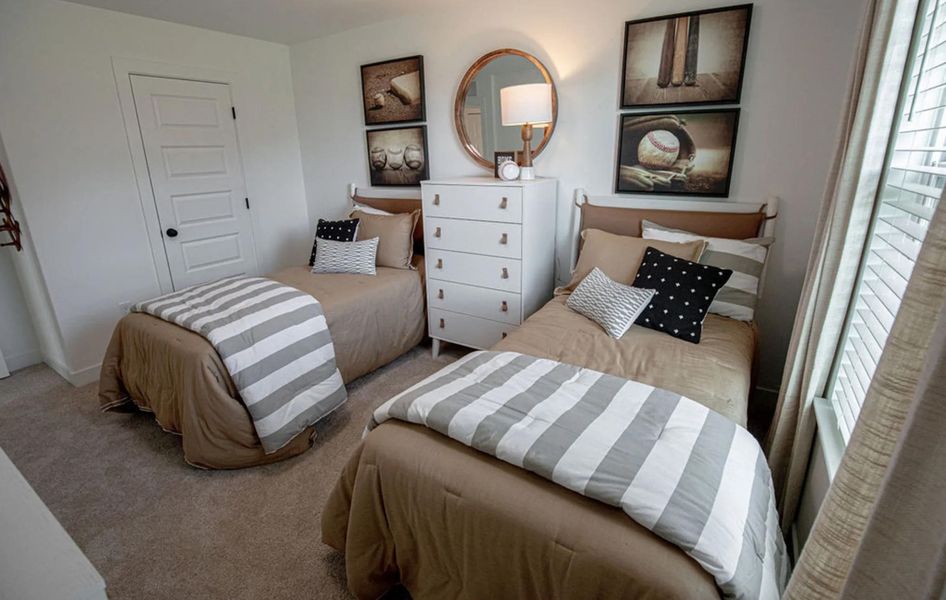 Carpeted bedroom with a closet