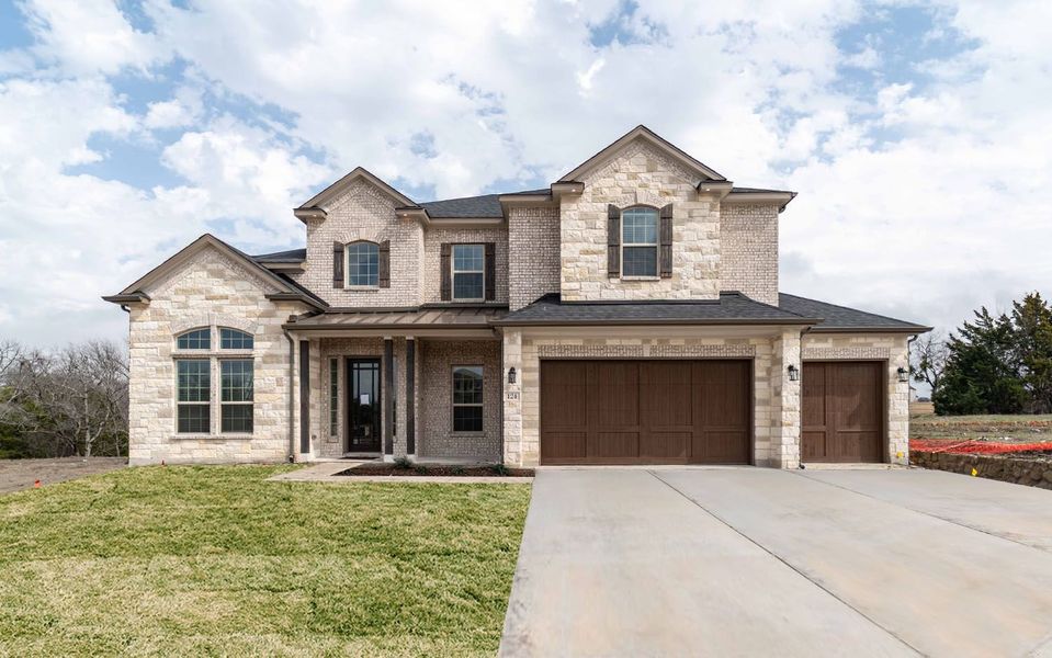 Front exterior of a new home in Heath Golf & Yacht Club, Forney, TX, highlighting curb appeal (Image 1). Front exterior of a new home in Heath Golf & Yacht Club, Forney, TX, highlighting curb appeal (Image 1).