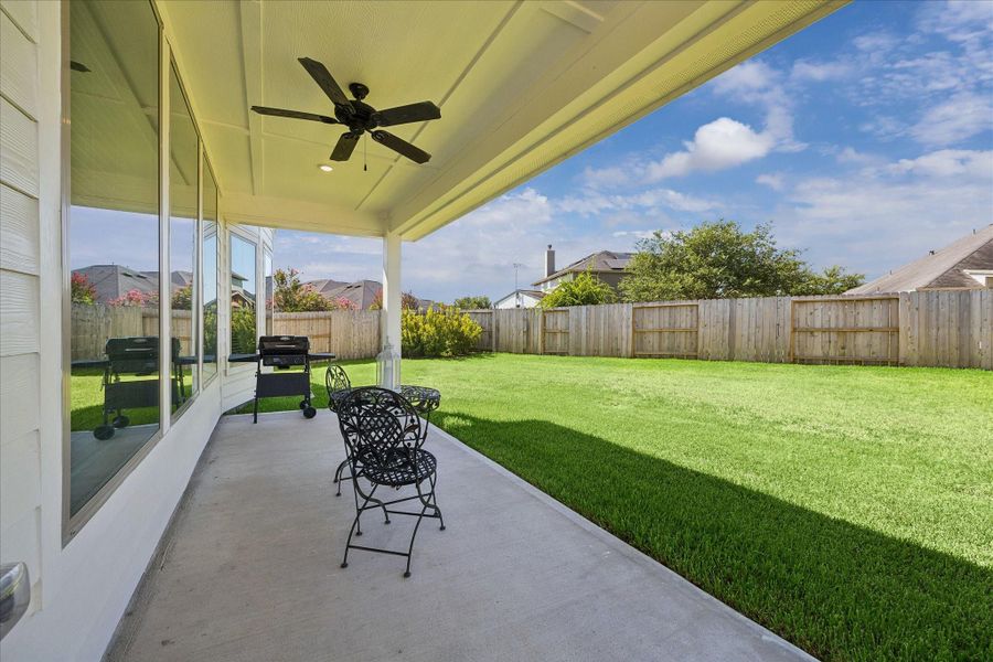 You can sit out on this back patio under the ceiling fan and drink your morning coffee or your adult beverages. This lot is oversized and there is plenty of room for gardening, a pool, or a grilling or barbeque station.