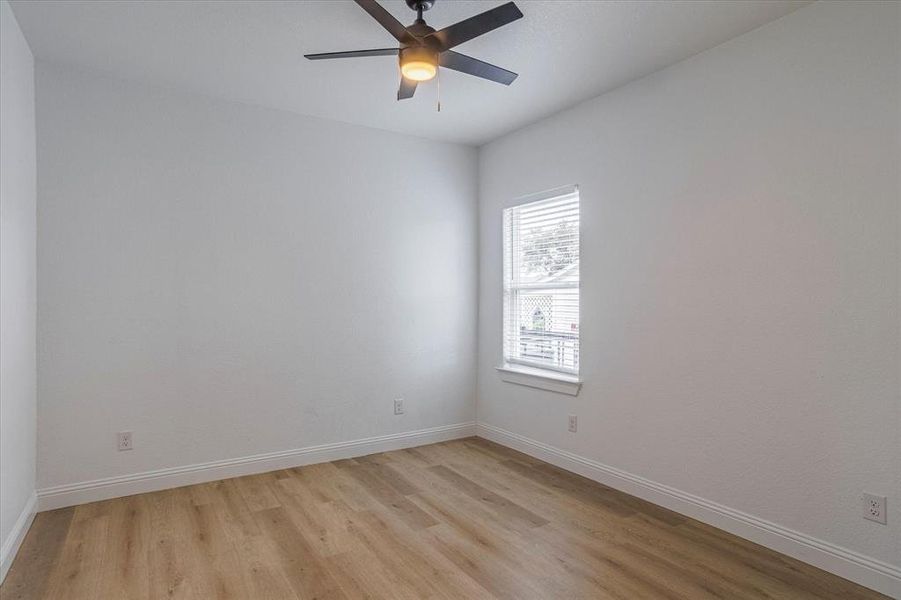 Empty room featuring ceiling fan and light wood-type flooring