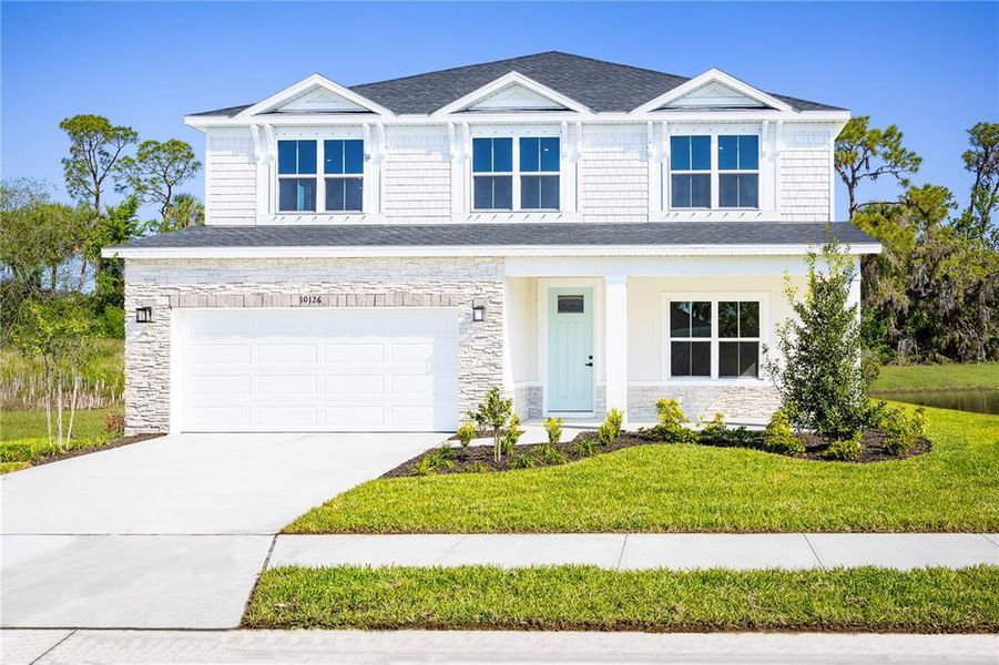 Front exterior of a new home in Lake Mattie Preserve Estates, Auburndale, FL, highlighting curb appeal (Image 1).