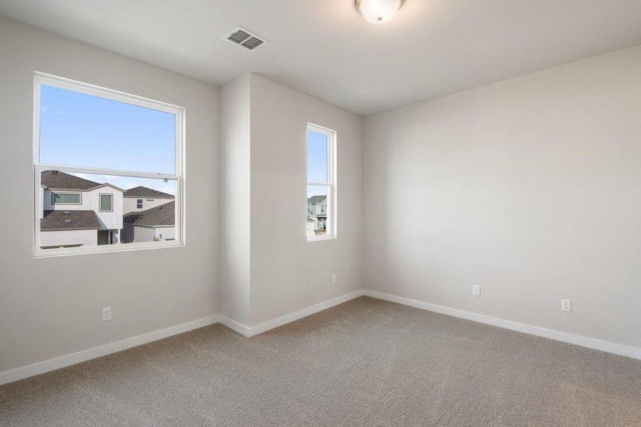 Empty room with light carpet and baseboards
