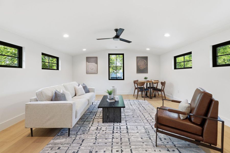 Living area featuring recessed lighting, light wood-style floors, and a ceiling fan