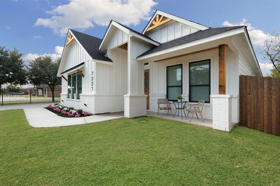View of front of property with board and batten siding, brick siding, and a shingled roof View of front of property with board and batten siding, brick siding, and a shingled roof