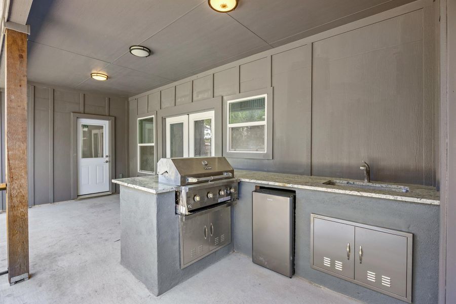 View of patio / terrace with grilling area, a sink, and exterior kitchen View of patio / terrace with grilling area, a sink, and exterior kitchen
