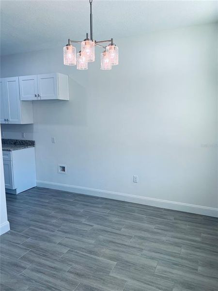 View of the Dinning room and the area where the fridge will be place.