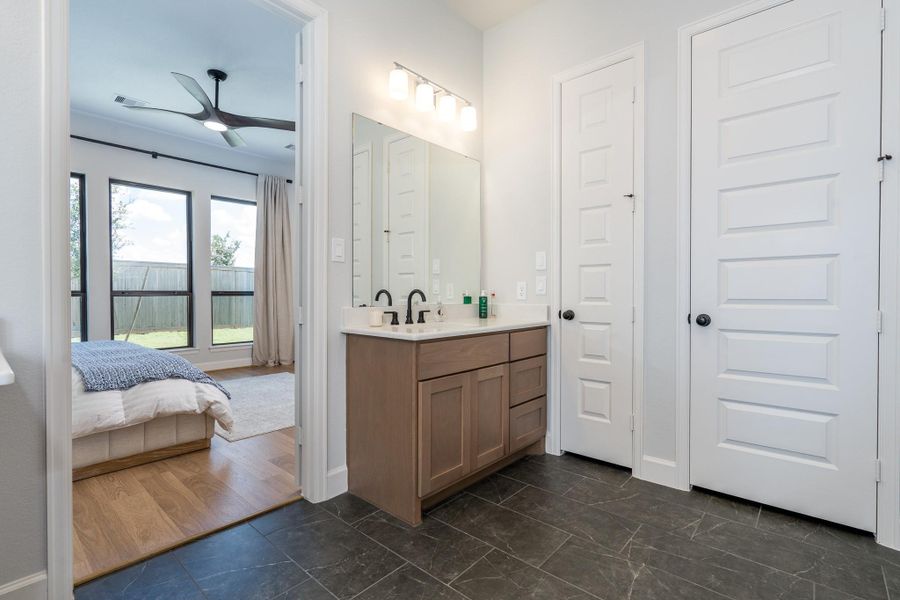 Primary bath has updated vanity sinks and matte black faucets. Primary bath has updated vanity sinks and matte black faucets.