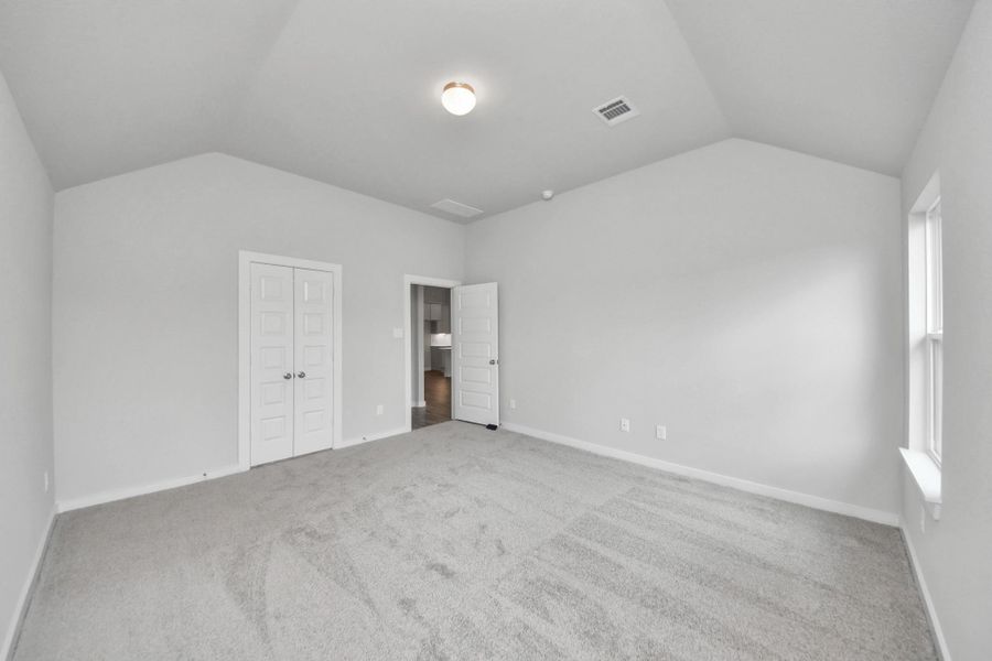 Escape and relax in the exquisite primary suite, a haven to unwind after a long day. The spacious room, located on first floor, boasts plush carpeting, soothing paint tones, high ceilings, and expansive windows adorned with privacy blinds. Sample photo of completed home with similar floor plan. Actual colors and selections may vary. Escape and relax in the exquisite primary suite, a haven to unwind after a long day. The spacious room, located on first floor, boasts plush carpeting, soothing paint tones, high ceilings, and expansive windows adorned with privacy blinds. Sample photo of completed home with similar floor plan. Actual colors and selections may vary.