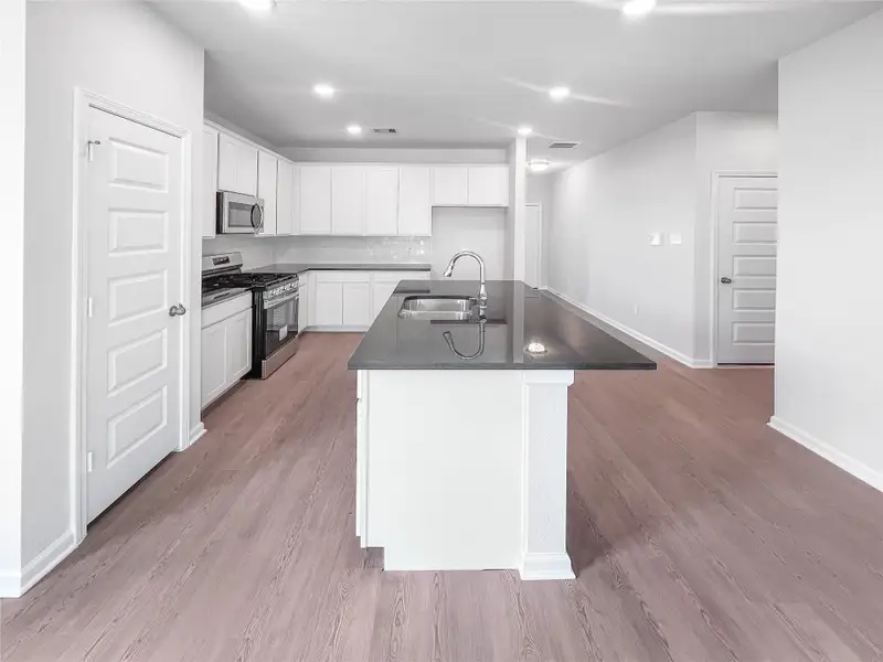 The Waring III- Kitchen with Large Island. Sample image for illustration; upgrades, options, and colors may vary.