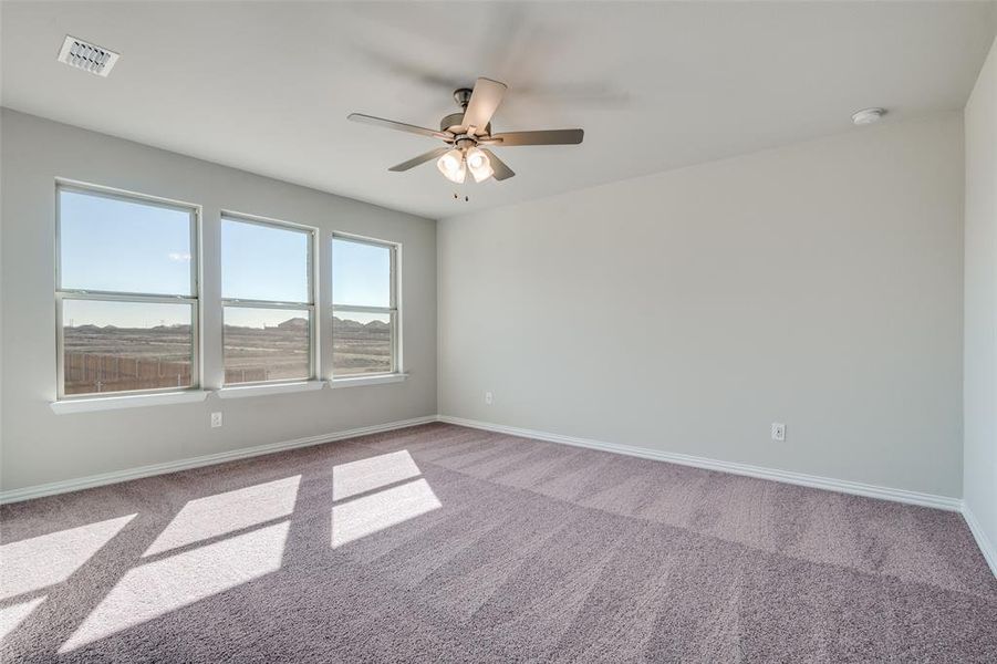 Unfurnished room with carpet floors and ceiling fan Unfurnished room with carpet floors and ceiling fan
