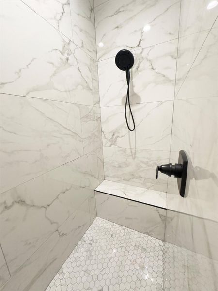 Floor-to-ceiling tile work and modern matte black fixtures define this refined walk-in shower. Floor-to-ceiling tile work and modern matte black fixtures define this refined walk-in shower.