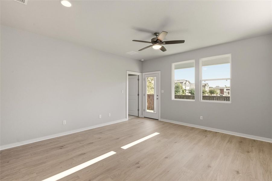 Spare room with light wood-style floors, ceiling fan, and recessed lighting