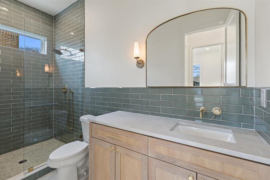 All bathrooms are elegantly appointed with marble countertops.