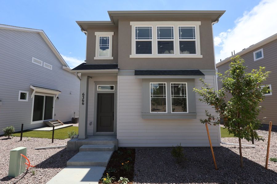Front exterior of a new home in Revel Crossing at Wolf Ranch – The Ascent Collection, Colorado Springs, CO, highlighting curb appeal (Image 20). Front exterior of a new home in Revel Crossing at Wolf Ranch – The Ascent Collection, Colorado Springs, CO, highlighting curb appeal (Image 20).