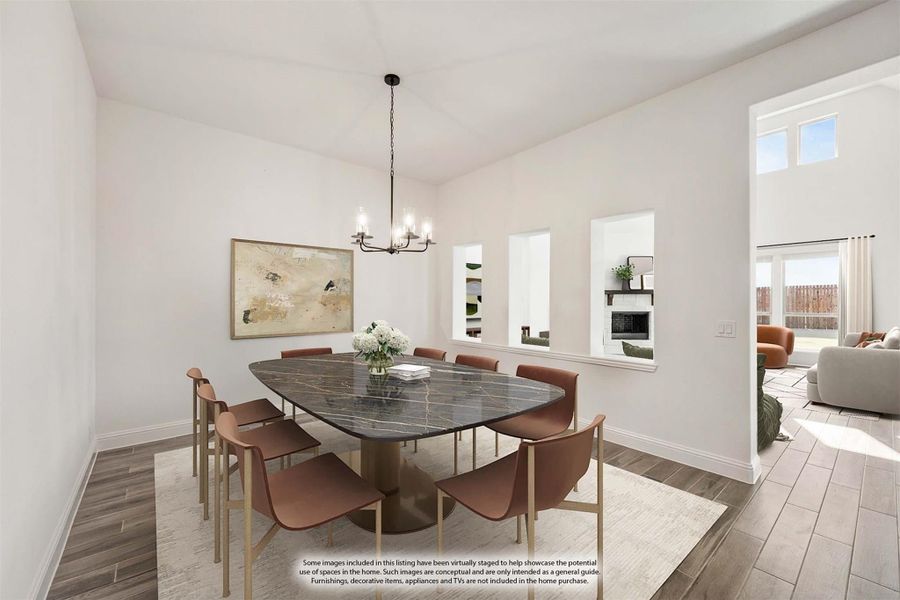 Dining room with dark marble table, eight chairs, chandelier, and wood-look floors open to living room Dining room with dark marble table, eight chairs, chandelier, and wood-look floors open to living room