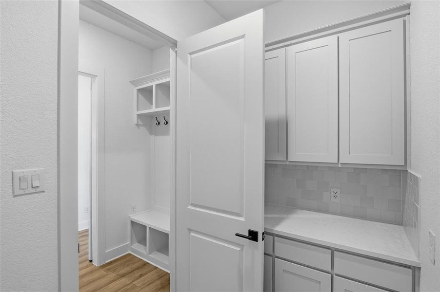 Mudroom featuring a textured wall and light wood-style floors