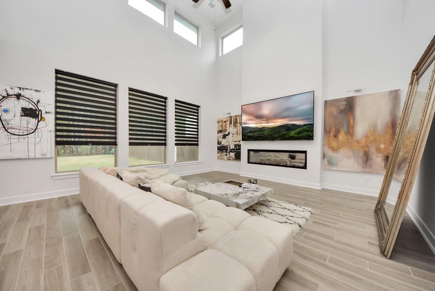 Bright living room with floor-to-ceiling windows and modern fireplace.