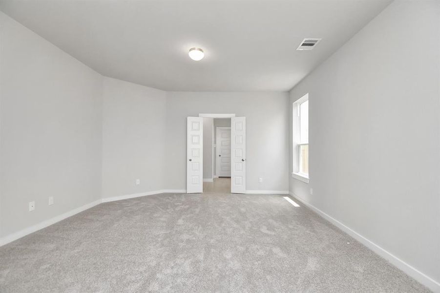 Large windows in the primary room for a bright and welcoming feel. Sample photo of completed home with similar floor plan. Actual colors and selections may vary.