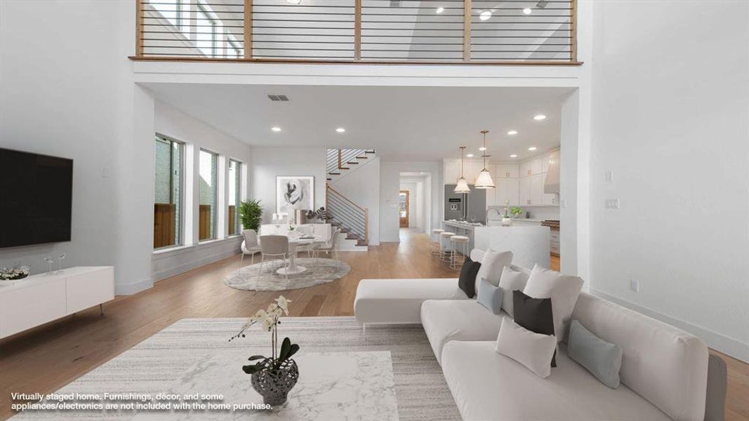 Living room featuring hardwood / wood-style floors and a towering ceiling