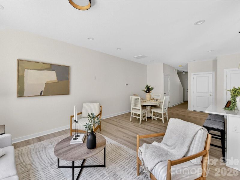 Bright and inviting family room filled with natural light, offering an open layout that seamlessly connects to the kitchen and dining area for comfortable everyday living. Bright and inviting family room filled with natural light, offering an open layout that seamlessly connects to the kitchen and dining area for comfortable everyday living.