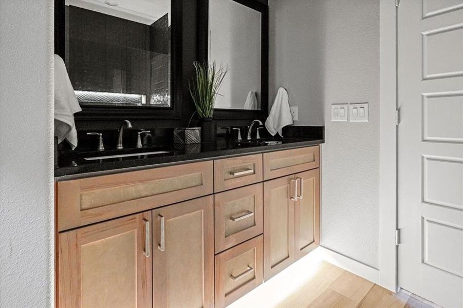 Bathroom featuring hardwood / wood-style flooring and vanity