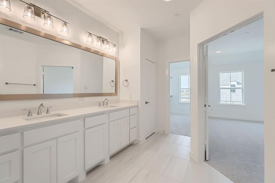 Bathroom featuring tile patterned flooring and vanity