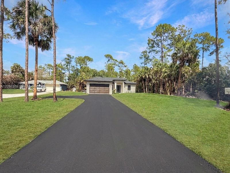 Contemporary single-story residence featuring and a paved driveway