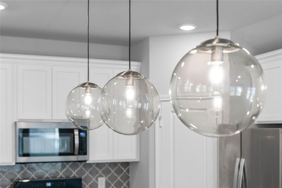 Atwell Brushed Nickel pendant lights that hang over the kitchen island. Atwell Brushed Nickel pendant lights that hang over the kitchen island.