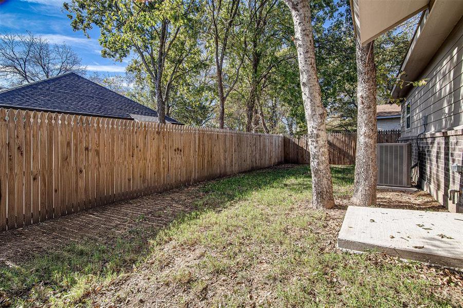 View of yard with central air condition unit and a patio area