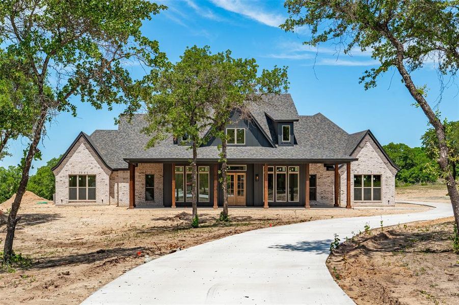 Front exterior of a new home in , Poolville, TX, highlighting curb appeal (Image 2). Front exterior of a new home in , Poolville, TX, highlighting curb appeal (Image 2).