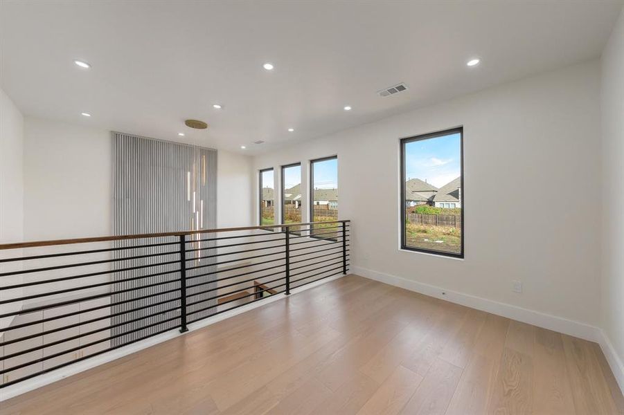 Empty room featuring light wood-style flooring and recessed lighting Empty room featuring light wood-style flooring and recessed lighting