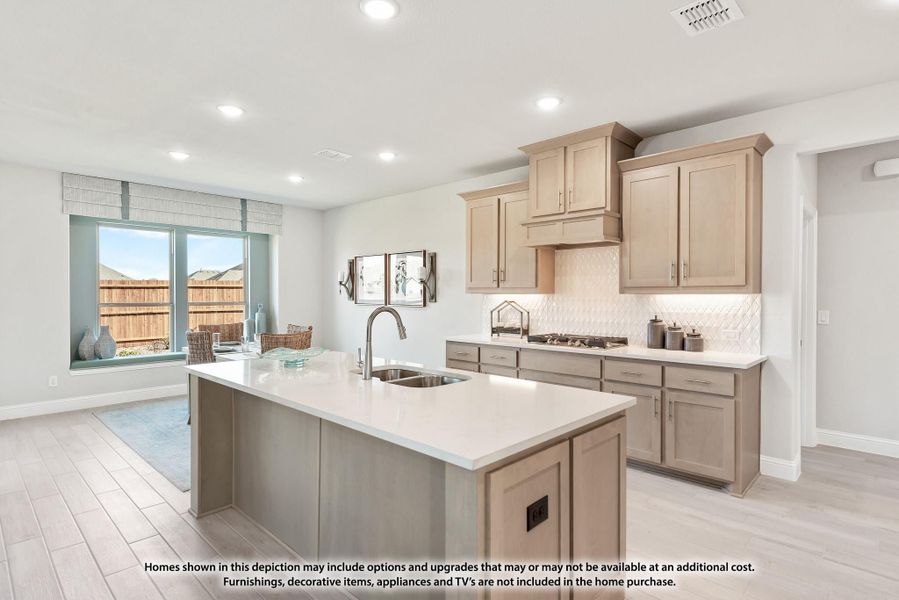 Kitchen with tan cabinets, center island with sink, white countertops, and tile backsplash open to dining area