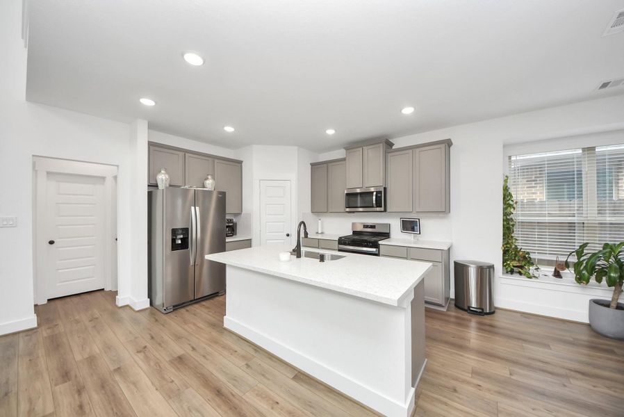 Light-filled kitchen featuring sleek cabinetry and an open, airy layout.