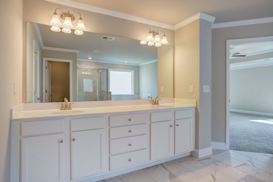 Dual vanities featured in the master bathroom