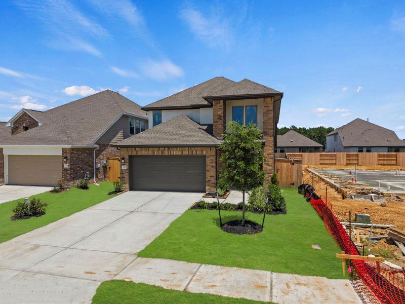 Front exterior of a new home in The Trails, New Caney, TX, highlighting curb appeal (Image 15).