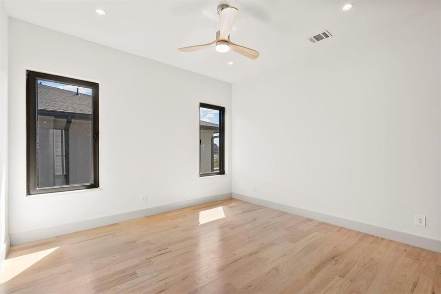 Spare room with ceiling fan and light wood-type flooring