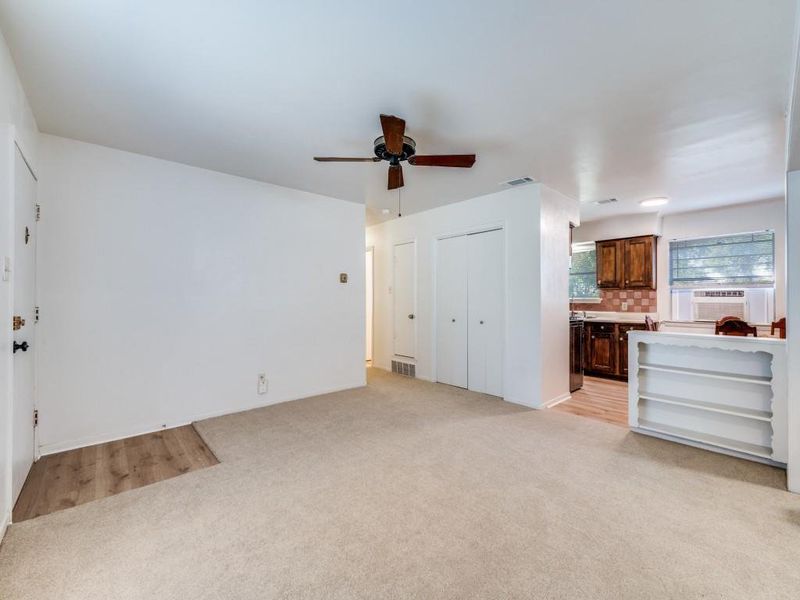 Unfurnished living room with light carpet and ceiling fan Unfurnished living room with light carpet and ceiling fan