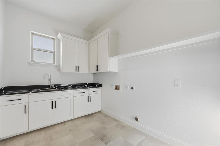 Laundry area featuring washer hookup, hookup for a gas dryer, cabinet space, and electric dryer hookup