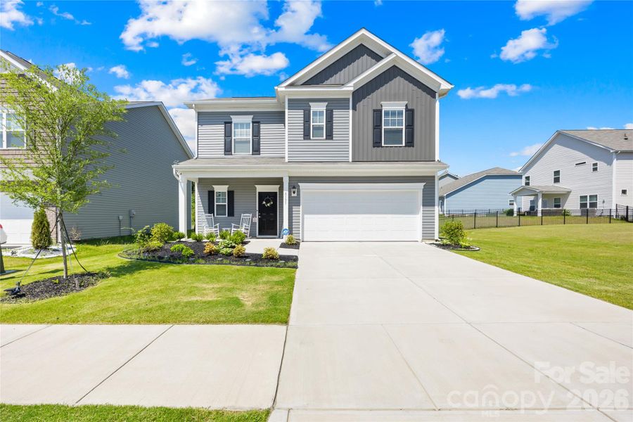 Front exterior of a new home in Orchard Creek, Charlotte, NC, highlighting curb appeal (Image 23).